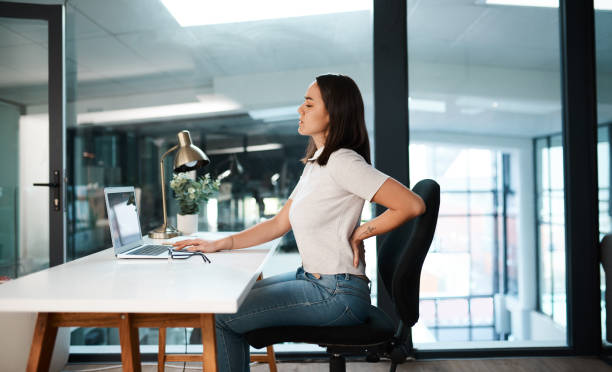 Proper sitting posture demonstration at computer desk